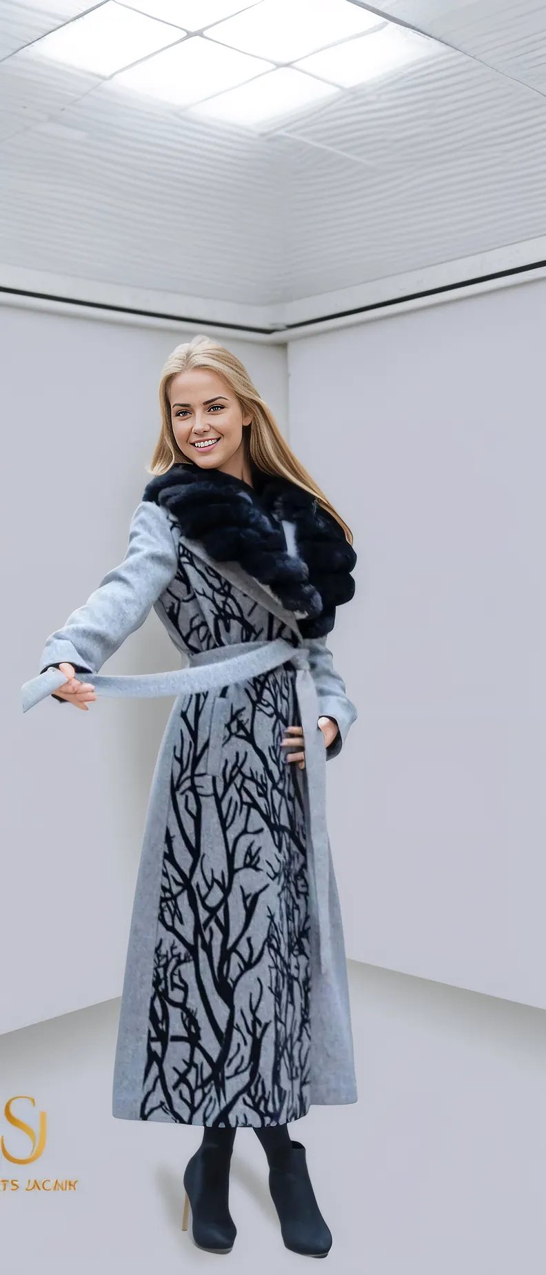 Elegant woman wearing a stylish gray winter coat with a black tree design and fur collar, perfect for cold weather fashion.