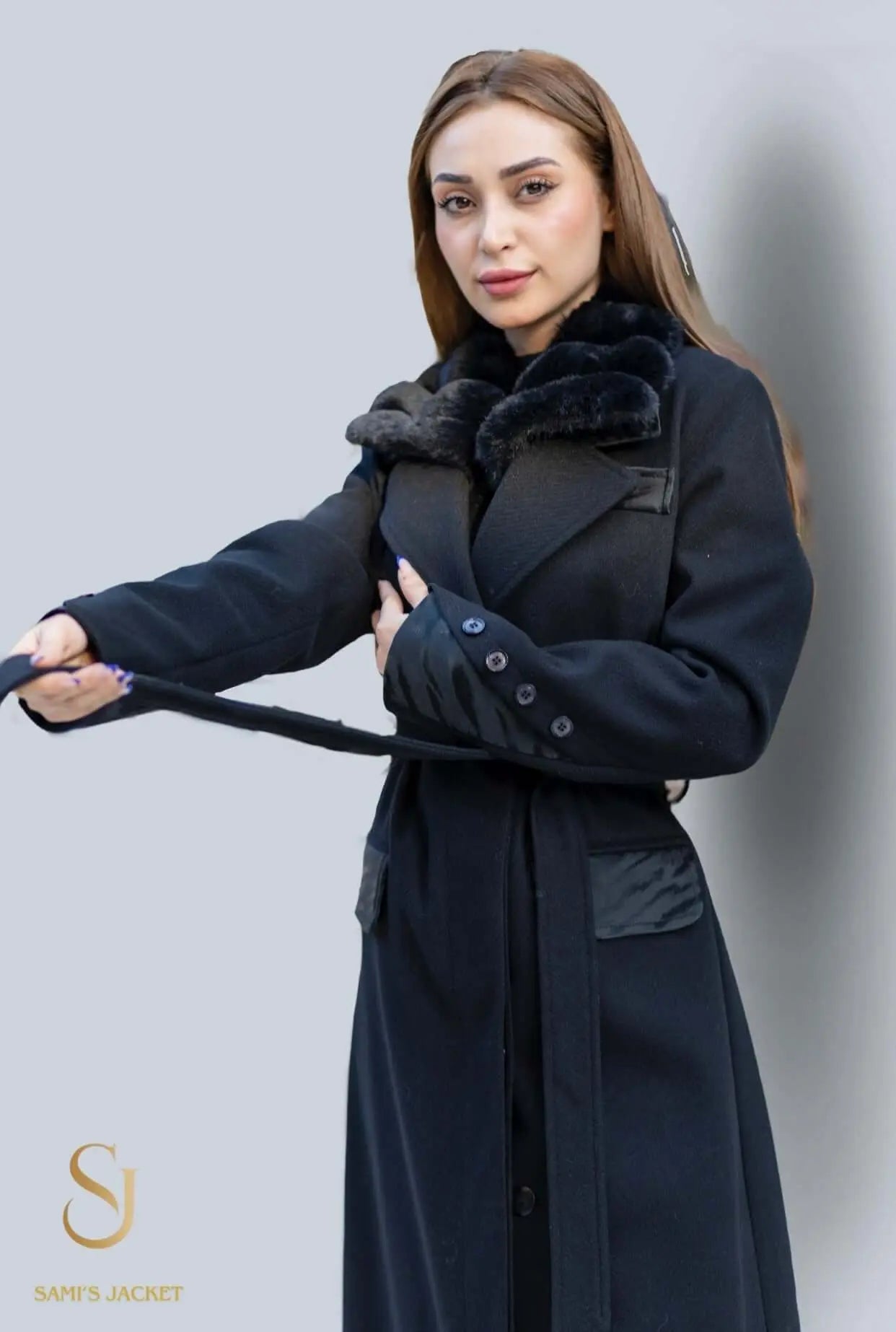 Stylish woman wearing a high-end black winter coat with fur collar, showcasing elegance and warmth for winter fashion.