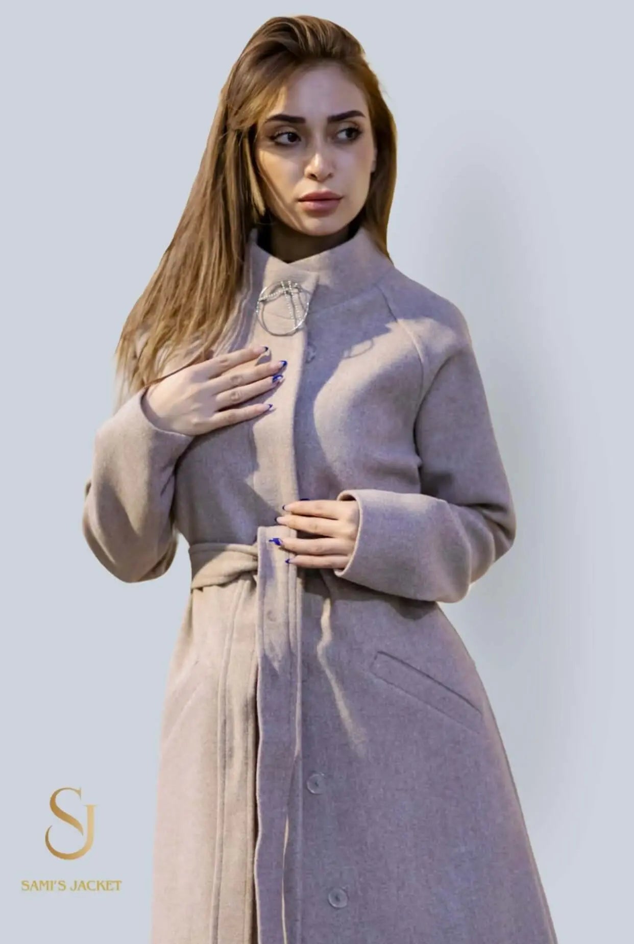 Elegant long winter coat in soft beige, showcasing stylish design and flattering silhouette for women’s winter fashion.