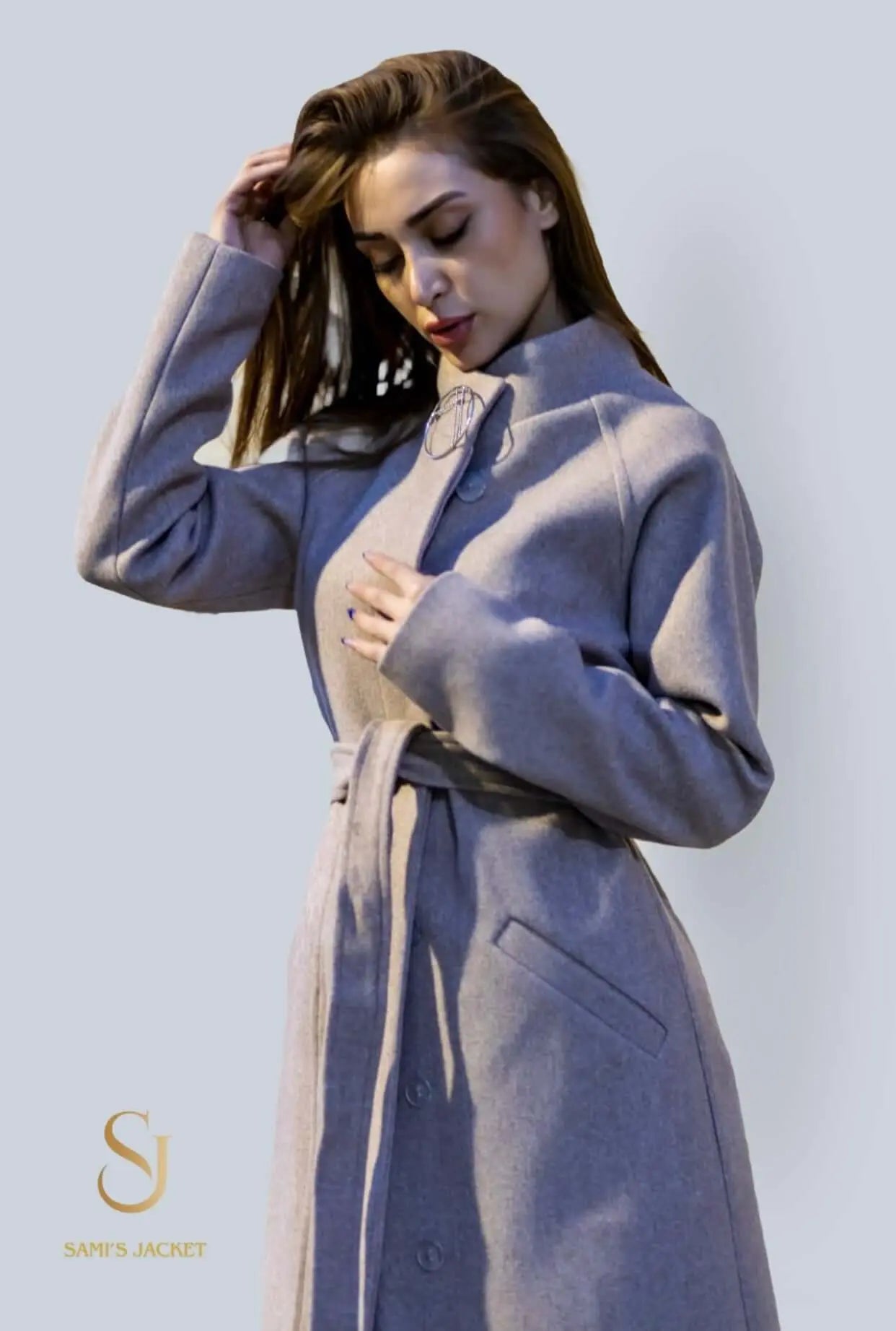 Elegant model wearing a stylish belted winter coat, showcasing comfort and warmth for women in chilly weather.