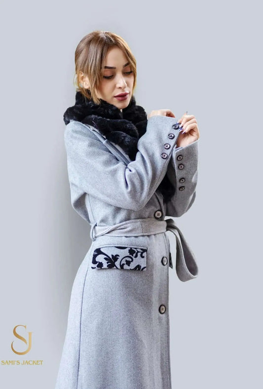 Elegant woman in grey long coat with fur collar, showcasing stylish winter fashion for women.