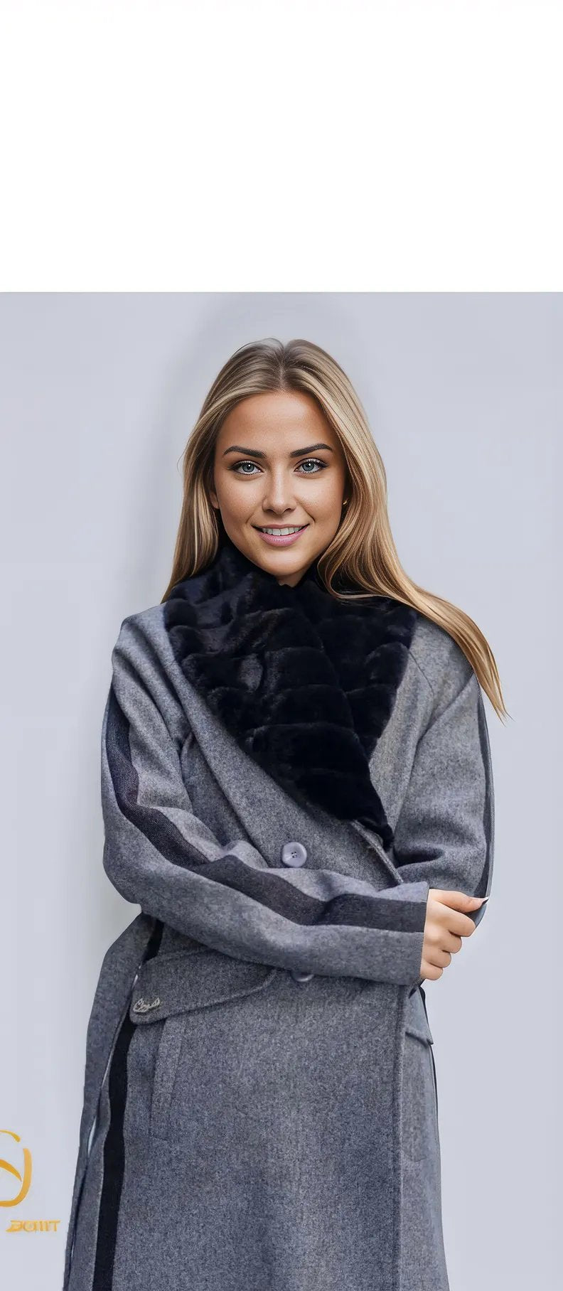 Stylish woman wearing a long grey coat with a black faux fur collar, showcasing elegance in winter fashion.