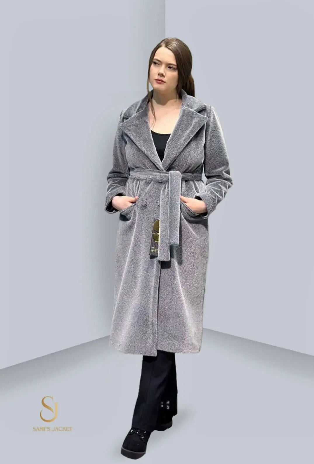 Sleek women's winter parka coat in gray, featuring a belt and practical pockets for style and warmth. Perfect for colder seasons.