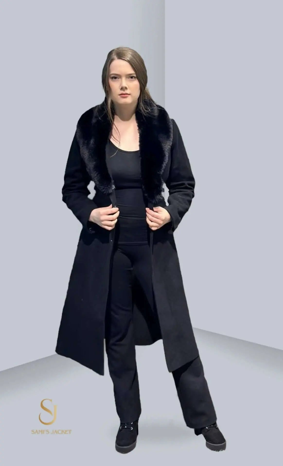 Woman showcasing a stylish black Model 1023 jacket with a fur collar, perfect for winter fashion and layering.