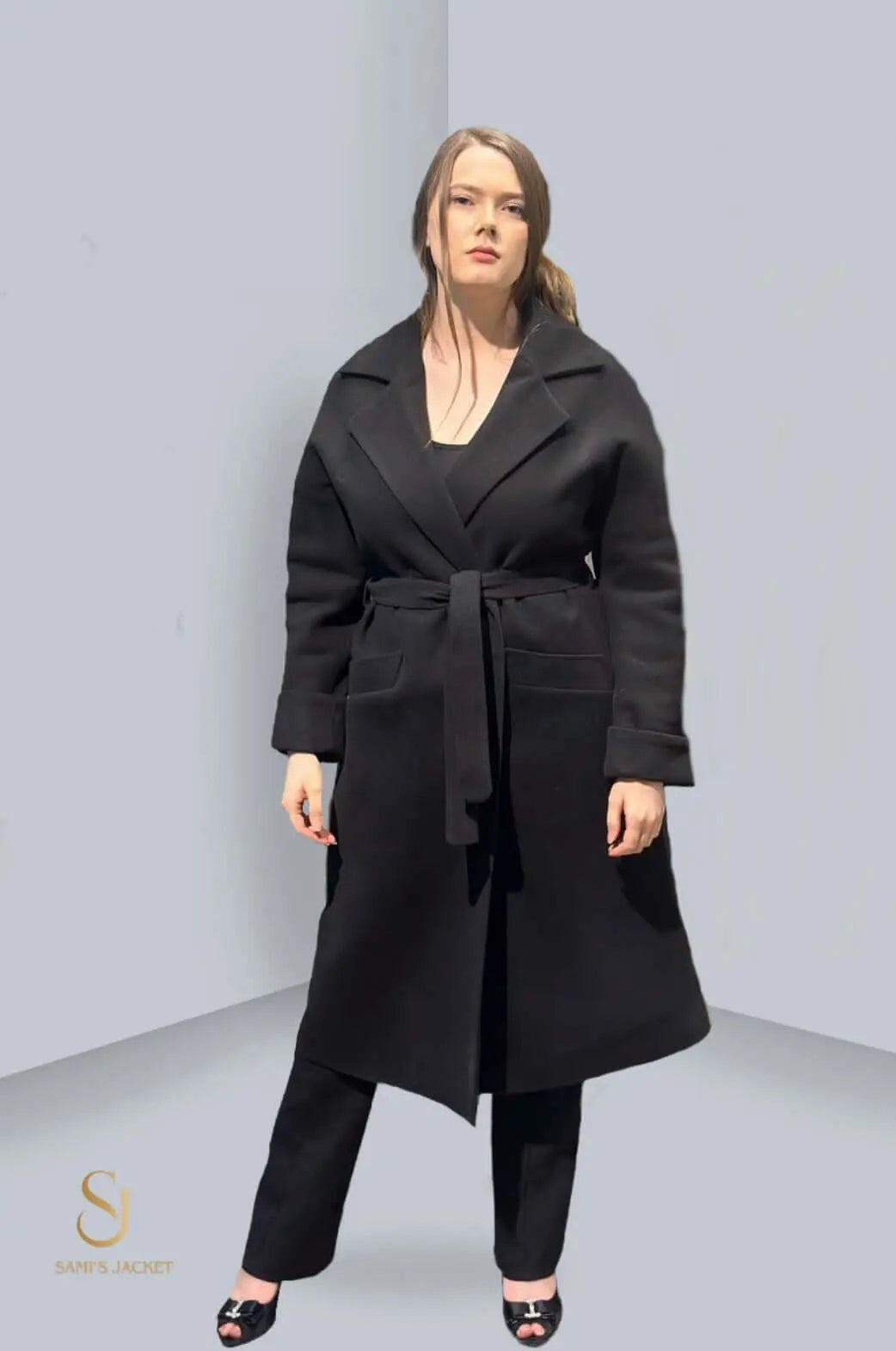 Black tailored winter jacket with belt, showcasing modern style and comfort for women in colder seasons.