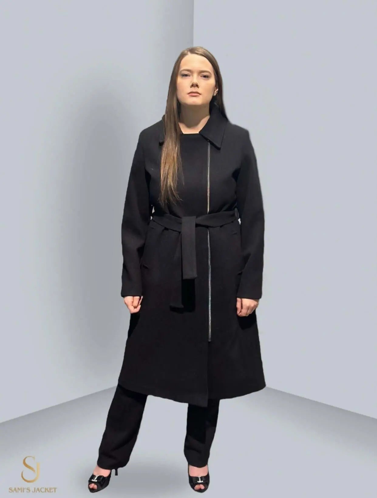 Woman wearing a stylish black Model 1011 jacket with a belt, showcasing modern design and tailored fit for winter fashion.