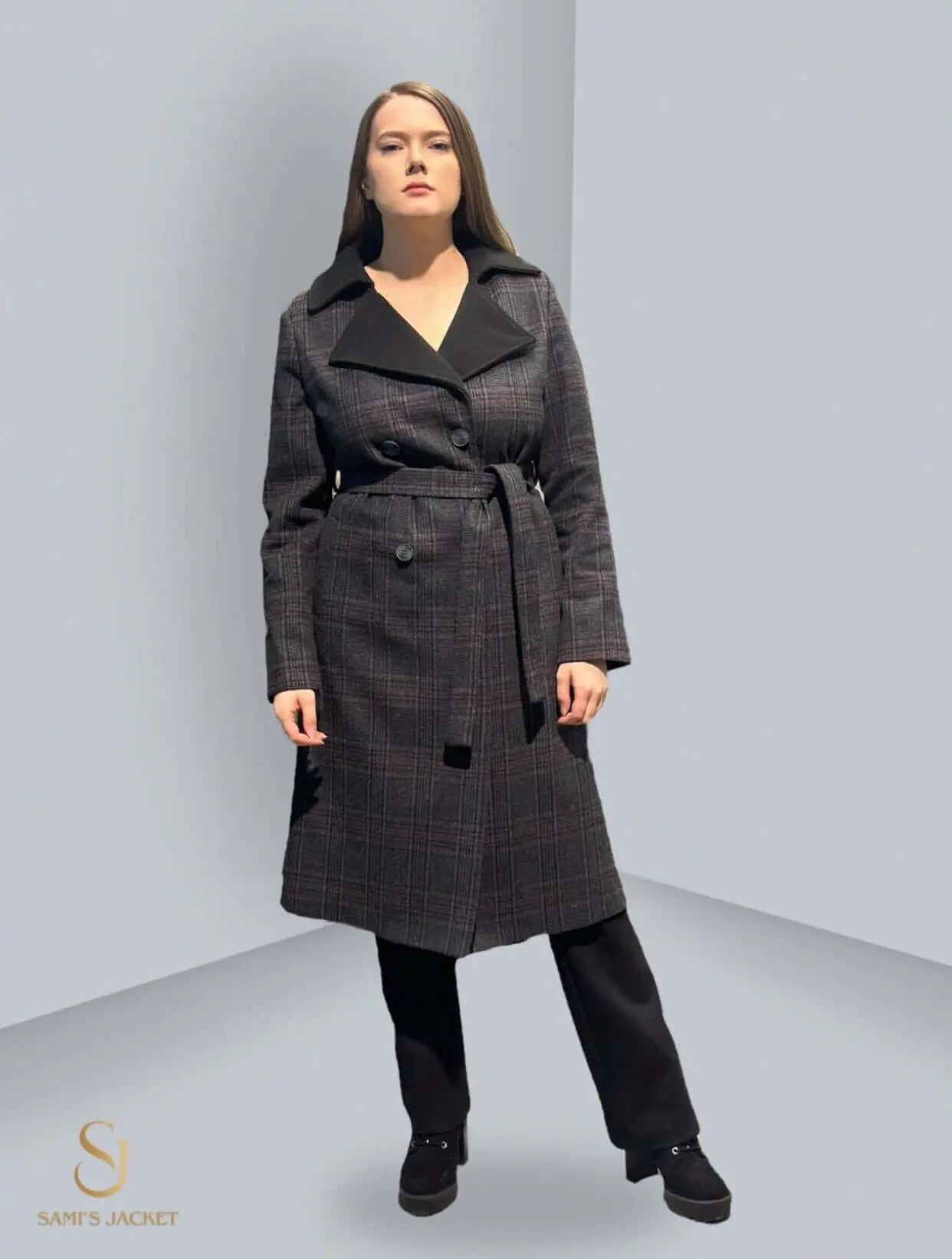 Stylish woman wearing a black and grey plaid winter coat, perfect for layering and modern fashion trends.