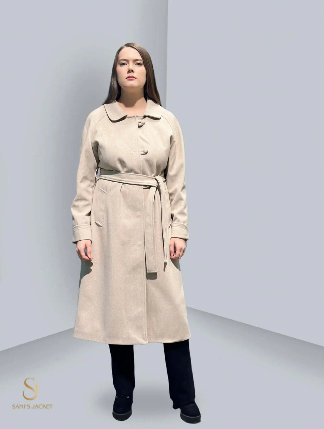 Model wearing a stylish beige winter jacket, showcasing a modern design with a tailored fit and belted waist.