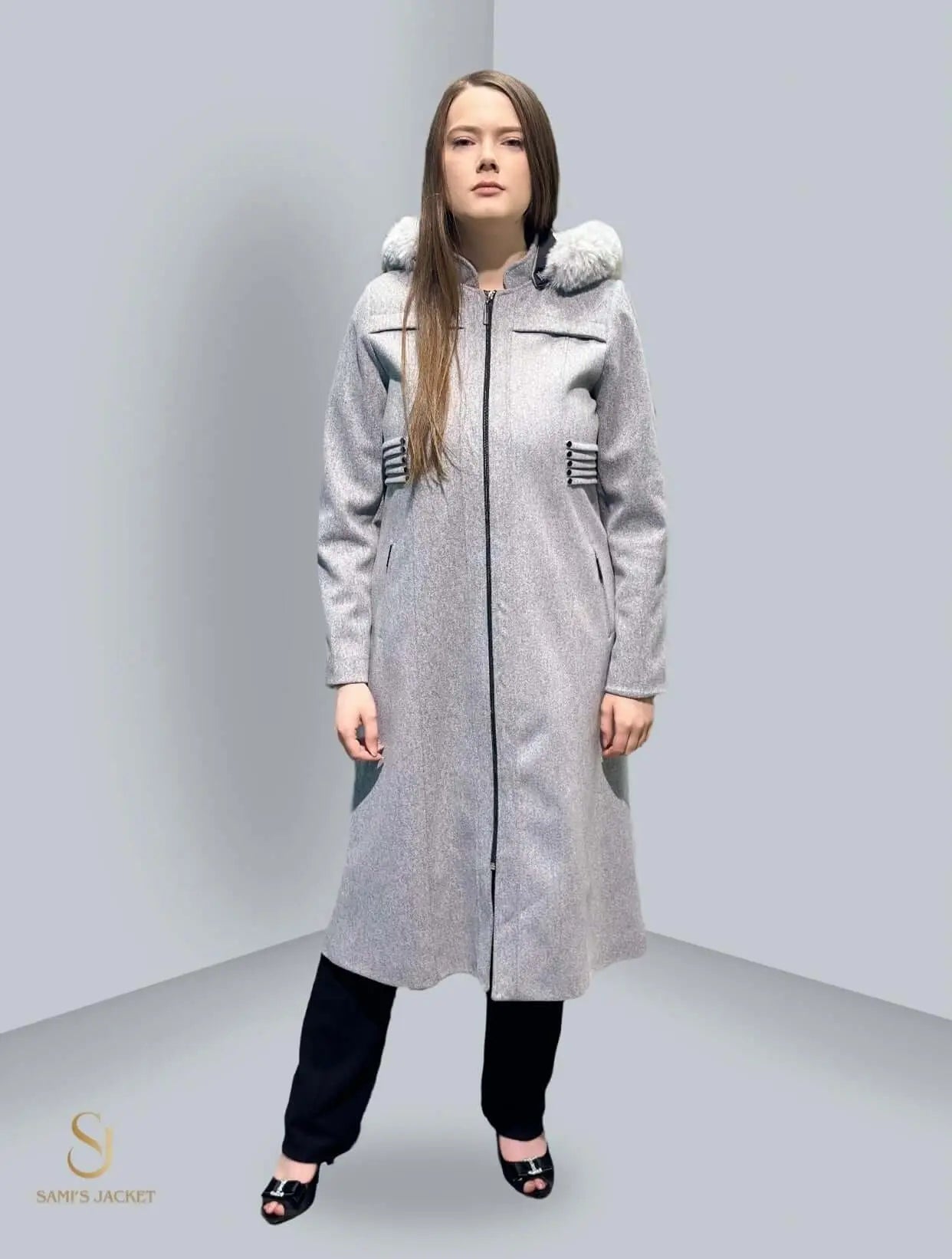 Stylish woman in a gray winter jacket with hood, showcasing modern design and practical features for cold weather.