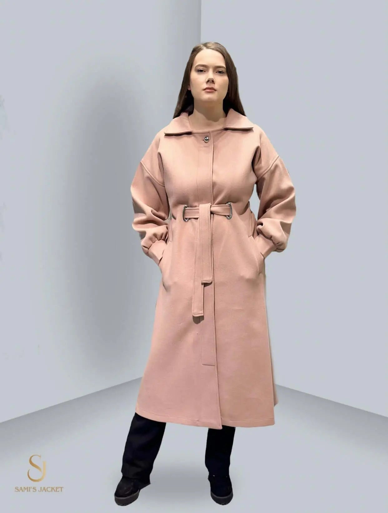 Model 1030 - Elegant long winter coat in pink, featuring a belted waist and stylish design, perfect for cold weather.