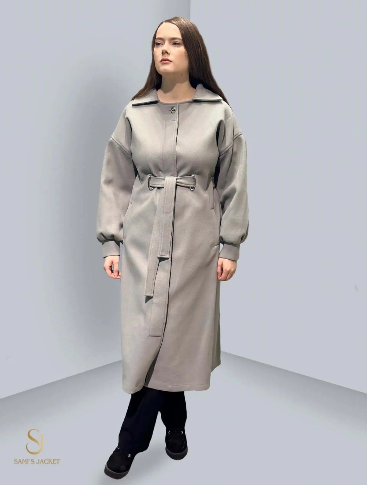 Woman wearing the stylish Model 1030 long winter coat in grey, showcasing a flattering silhouette and elegant design.