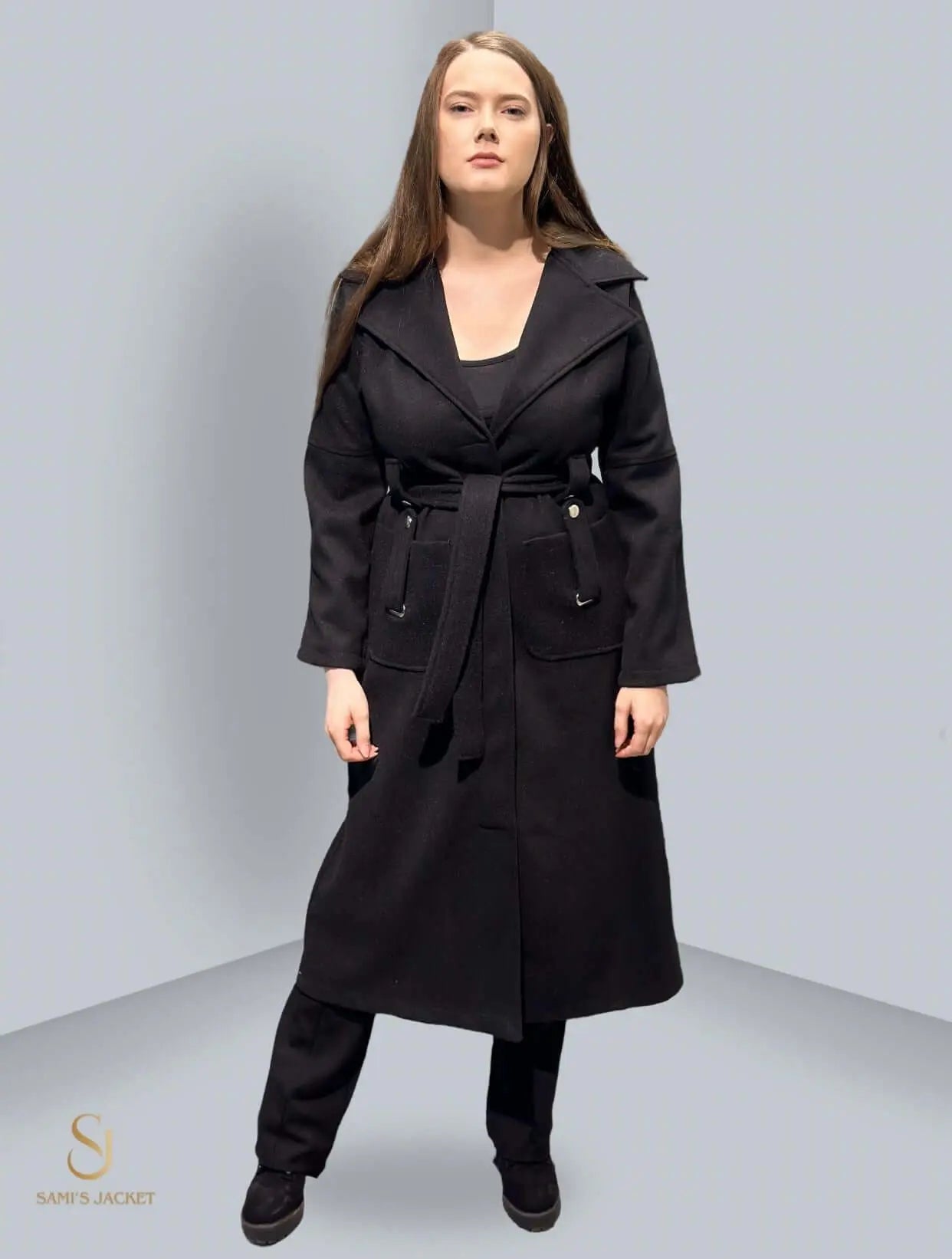 Woman wearing long black winter coat with belted waist and elegant design, showcasing the sophistication of Model 1034 coat.